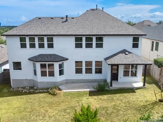 an aerial view of a house with a big yard