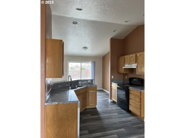 a kitchen with sink and cabinets