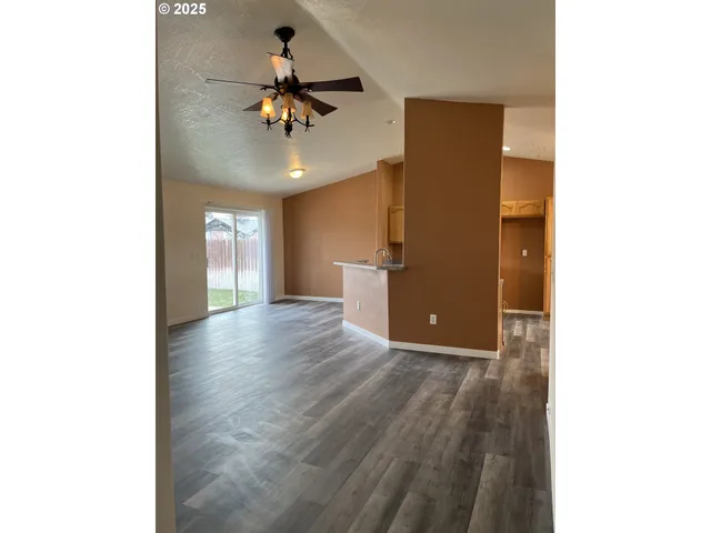 a view of a livingroom with a chandelier fan