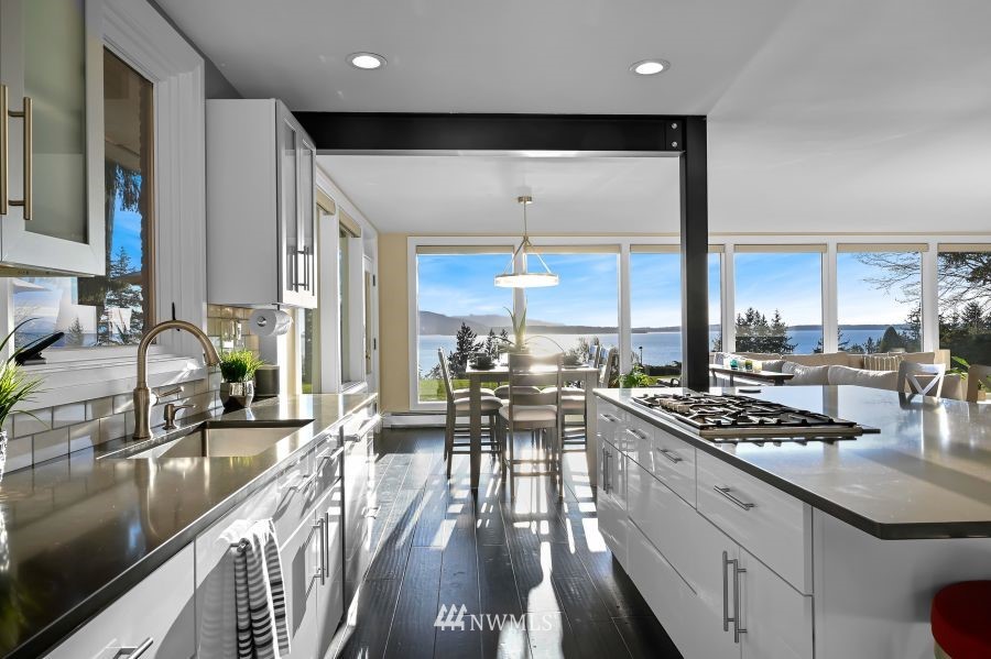 424 Fieldston Road Bellingham, WA 98225 - Photo 8 of 39 a kitchen with stainless steel appliances a stove a sink a oven a dining table and chairs