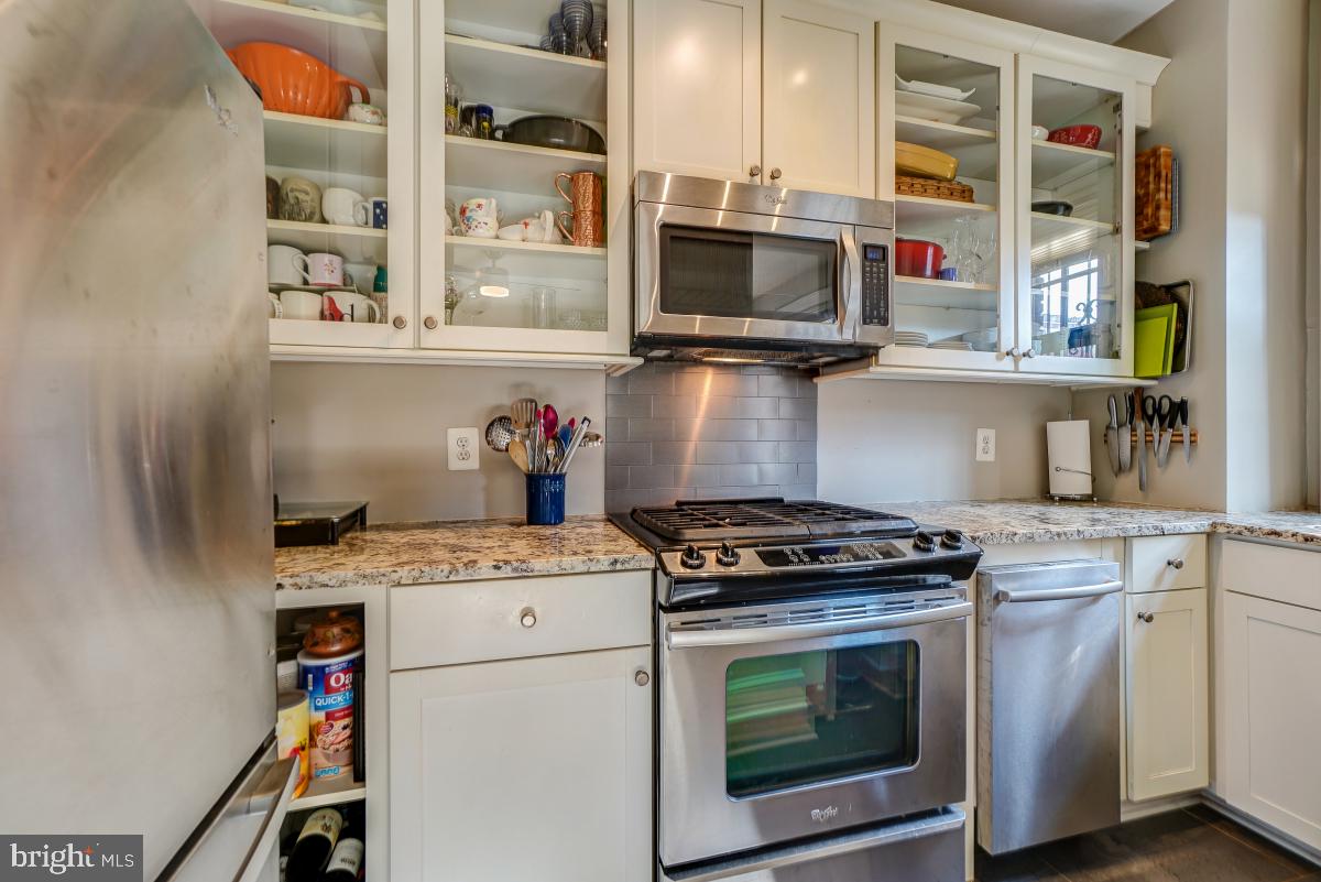 1101 L Street Northwest, Unit 102 Washington, DC 20005 - Photo 21 of 38 Custom 42" wood cabinetry with glass doors
