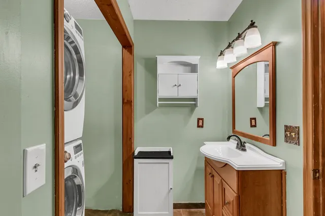 a bathroom with a sink a mirror and a shower