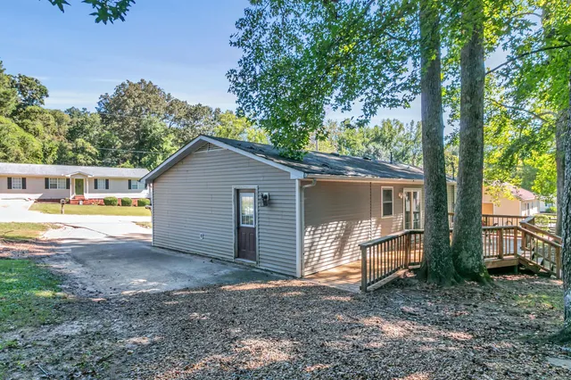 a view of a house with backyard and a tree