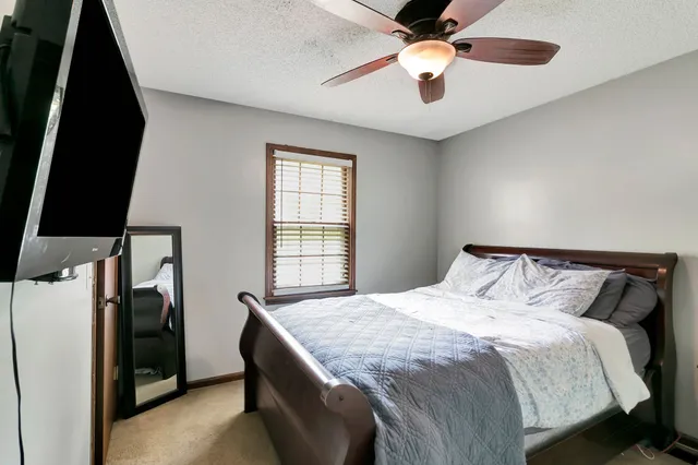 a bedroom with a bed and a chandelier