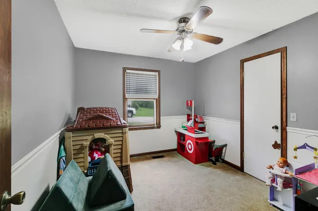 a children room with toys and a chandelier