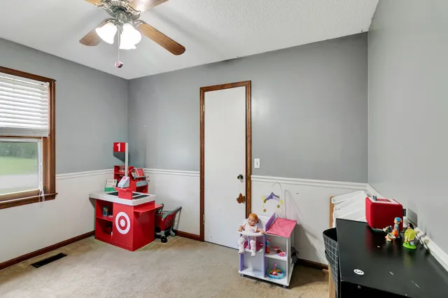 a bedroom with furniture and a window