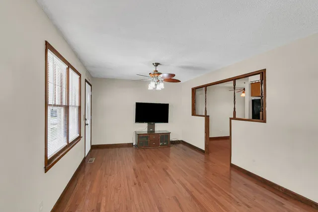 a view of livingroom with hardwood floor and workspace