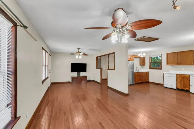 a view of living room with furniture and wooden floor