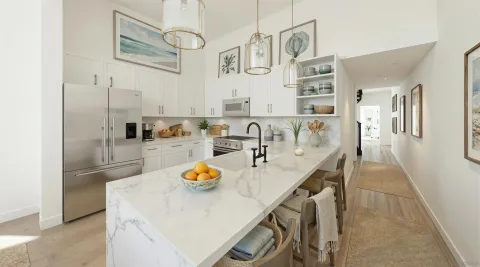 a view of a kitchen with stainless steel appliances a dining table and chairs