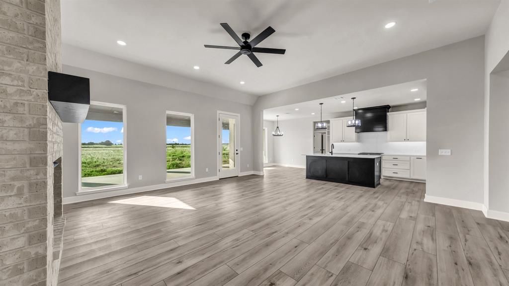 151 County Road 2610 Decatur, TX 76234 - Photo 11 of 38 Living looking into kitchen, large island and bright windows