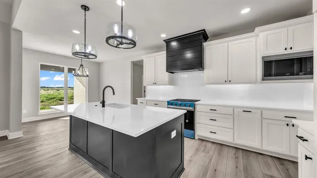a kitchen with a sink and a stove top oven