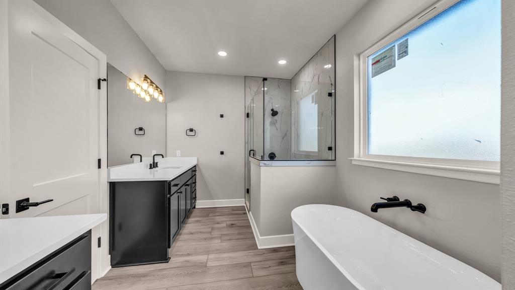 151 County Road 2610 Decatur, TX 76234 - Photo 21 of 38 Primary bath features 2 sink areas, a designer freestanding tub, a separate shower and lots of room in the large walk in closet