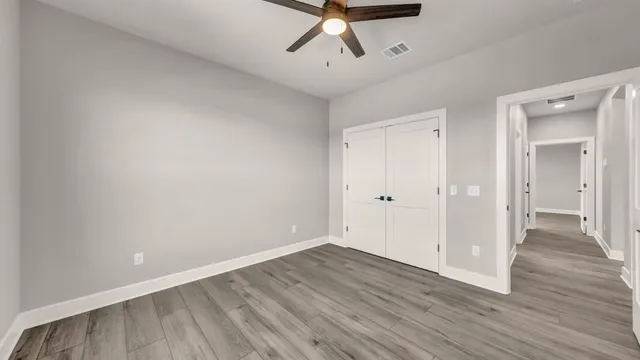 a view of a room with wooden floor and white walls