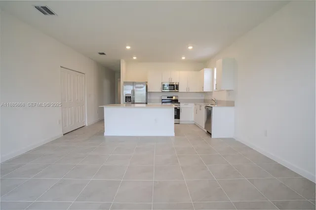 a view of counter top space and stainless steel appliances