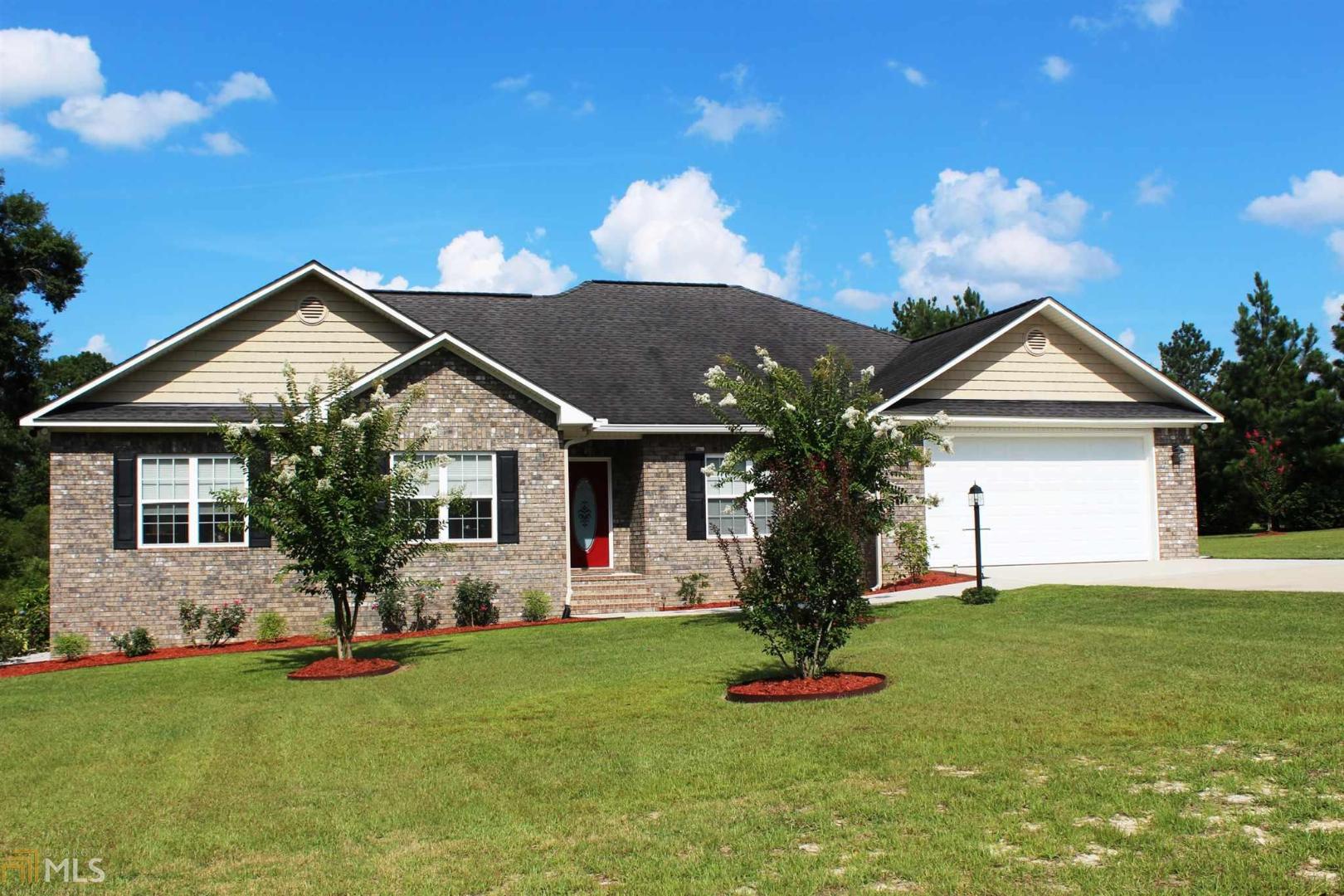 a front view of house with yard and green space