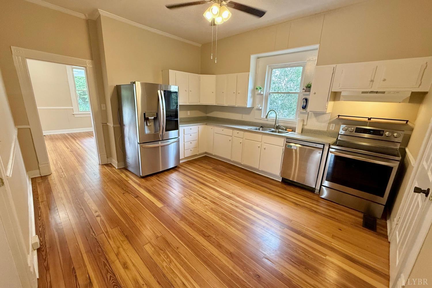 2225 Sabine Street Lynchburg, VA 24501 - Photo 7 of 13 a kitchen with a sink wooden floor and stainless steel appliances