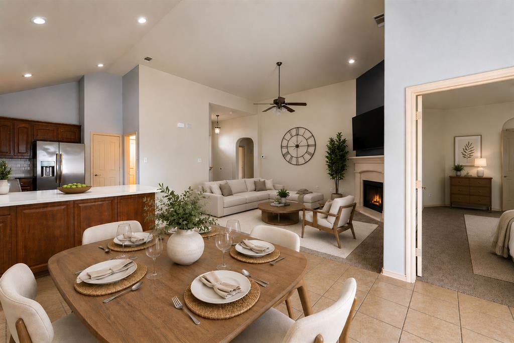 11156 Hawks Landing Road Fort Worth, TX 76052 - Photo 16 of 30 Virtual Staging of open living room and dining. Open-concept living area featuring vaulted ceilings, recessed lighting, a fireplace with a mantel, and a kitchen island with seating