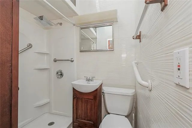 a white toilet sitting next to a bathroom sink