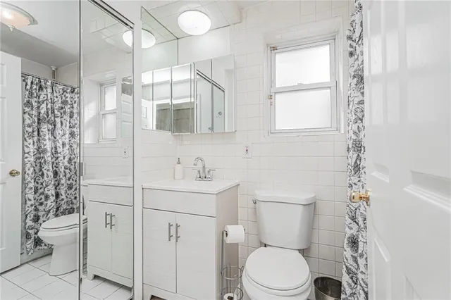 a bathroom with a toilet a sink and a shower