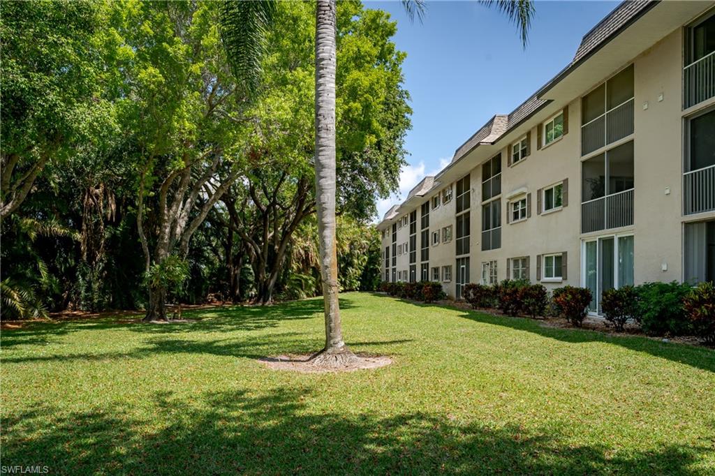 5419 Rattlesnake Hammock Road, Unit 307F Naples, FL 34113 - Photo 21 of 22 a view of a building with a yard