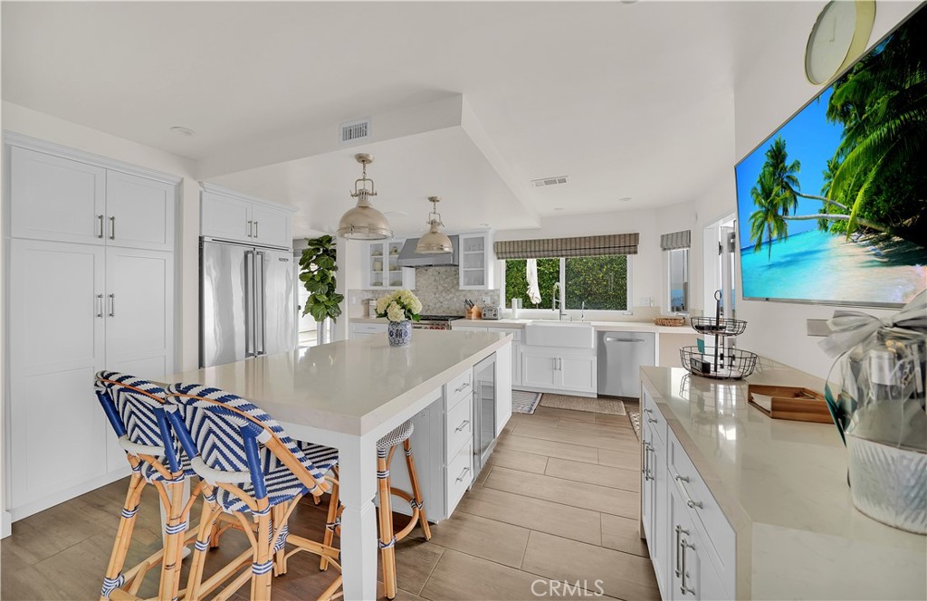 5 Regatta Way Dana Point, CA 92629 - Photo 12 of 32 a kitchen with stainless steel appliances a sink and a white cabinets