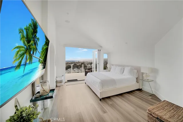 a bedroom with furniture and a flat screen tv