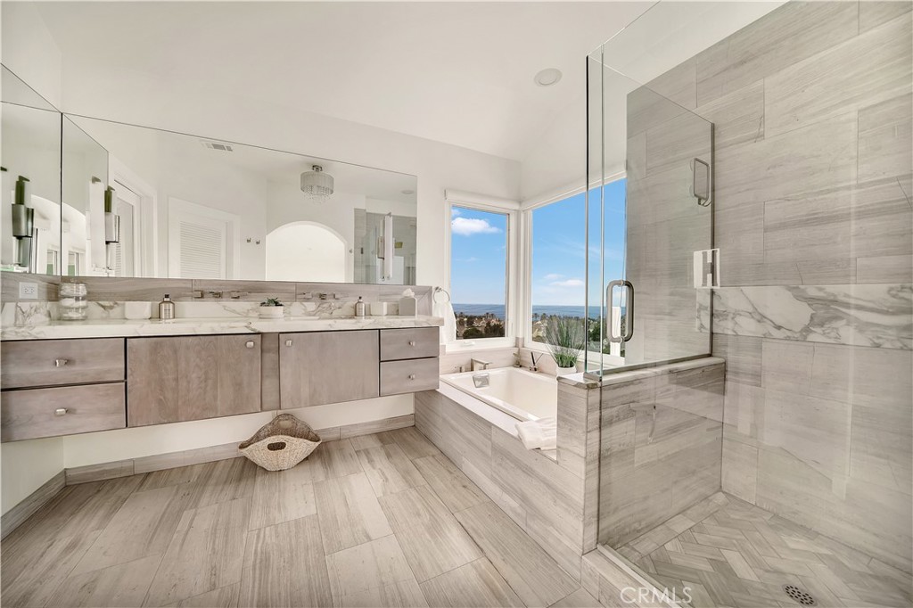 5 Regatta Way Dana Point, CA 92629 - Photo 22 of 32 a kitchen with stainless steel appliances a stove a sink and white cabinets with wooden floor
