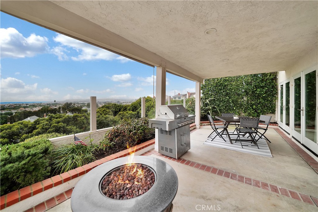 5 Regatta Way Dana Point, CA 92629 - Photo 30 of 32 a view of a patio with a table chairs and a garden