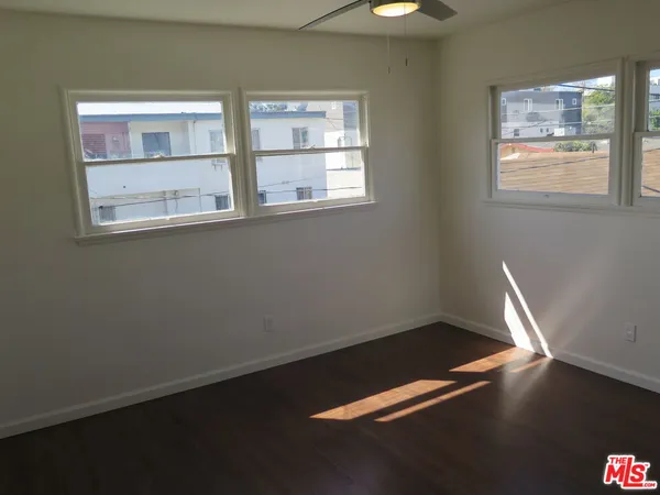 a view of room with window and wooden floor
