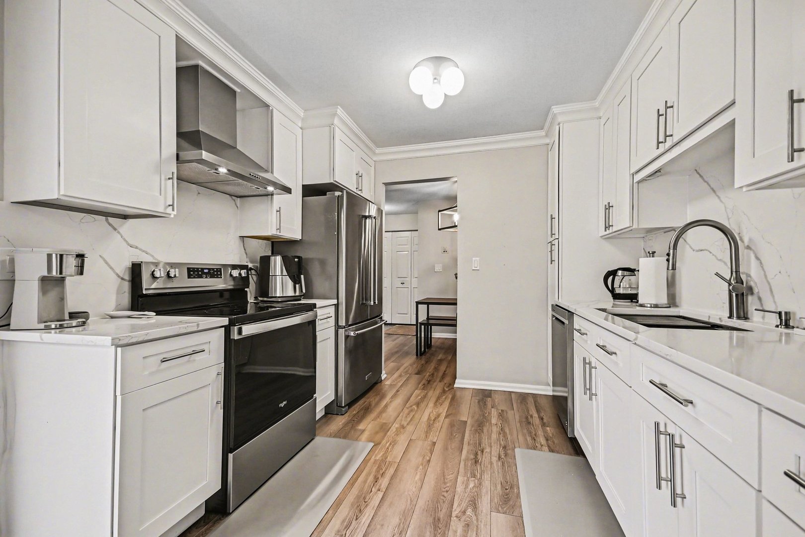 2057 Lancaster Circle, Unit 102D Naperville, IL 60565 - Photo 6 of 15 a kitchen with stainless steel appliances granite countertop a sink stove and refrigerator
