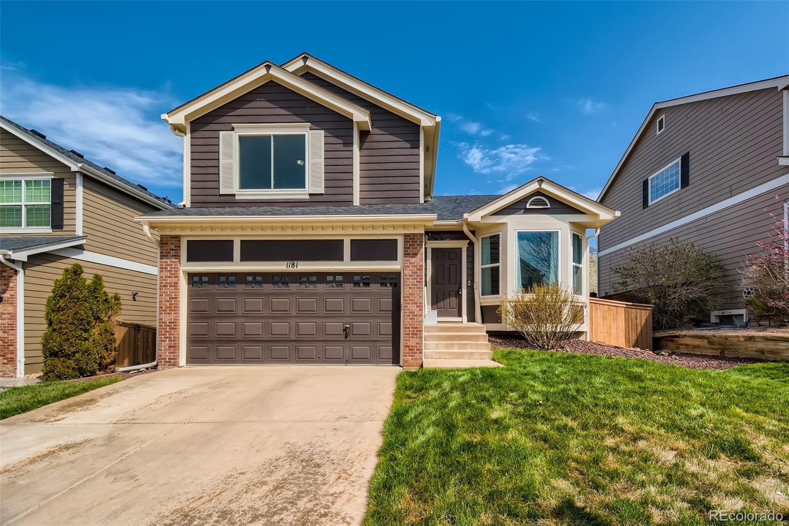 1181 Riddlewood Road Highlands Ranch, CO 80129 - Photo 1 of 25 a front view of a house with a yard