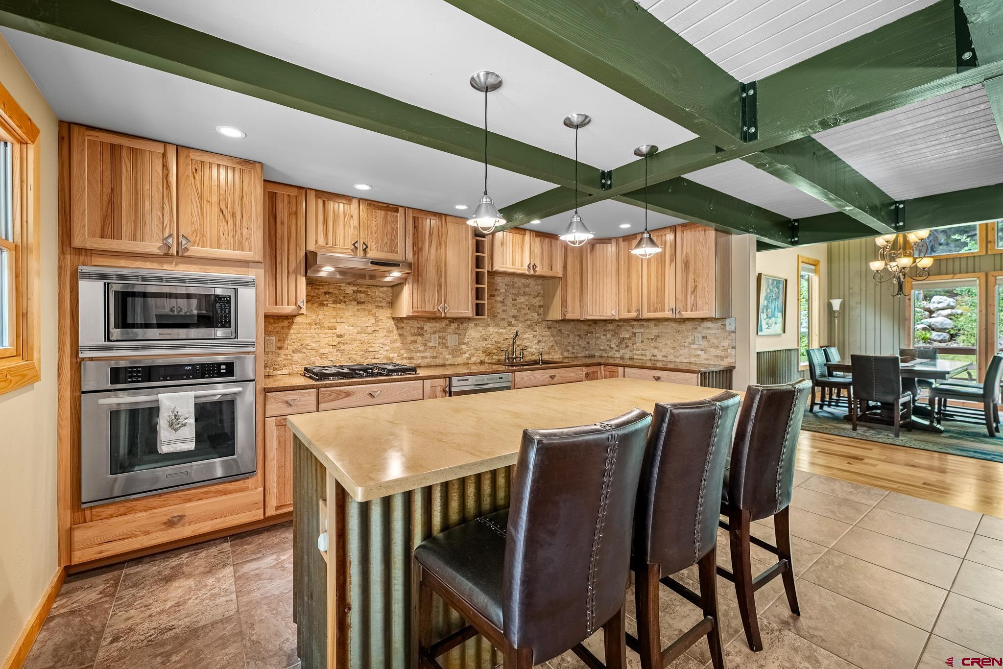 312 County Road 243 Durango, CO 81301 - Photo 15 of 33 a kitchen with stainless steel appliances granite countertop a stove a sink and a refrigerator