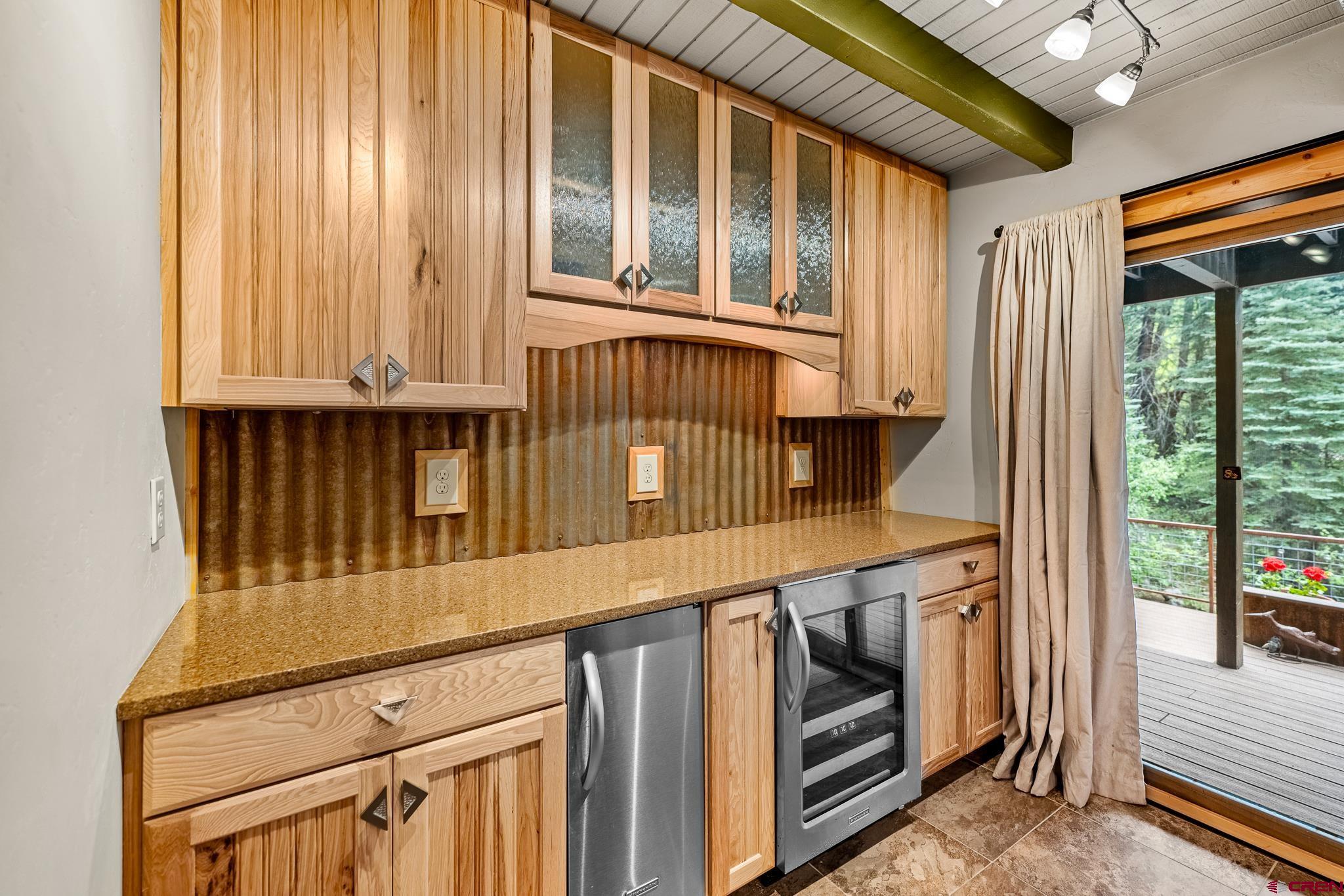 312 County Road 243 Durango, CO 81301 - Photo 18 of 33 a view of a kitchen with an entryway and a wooden floor