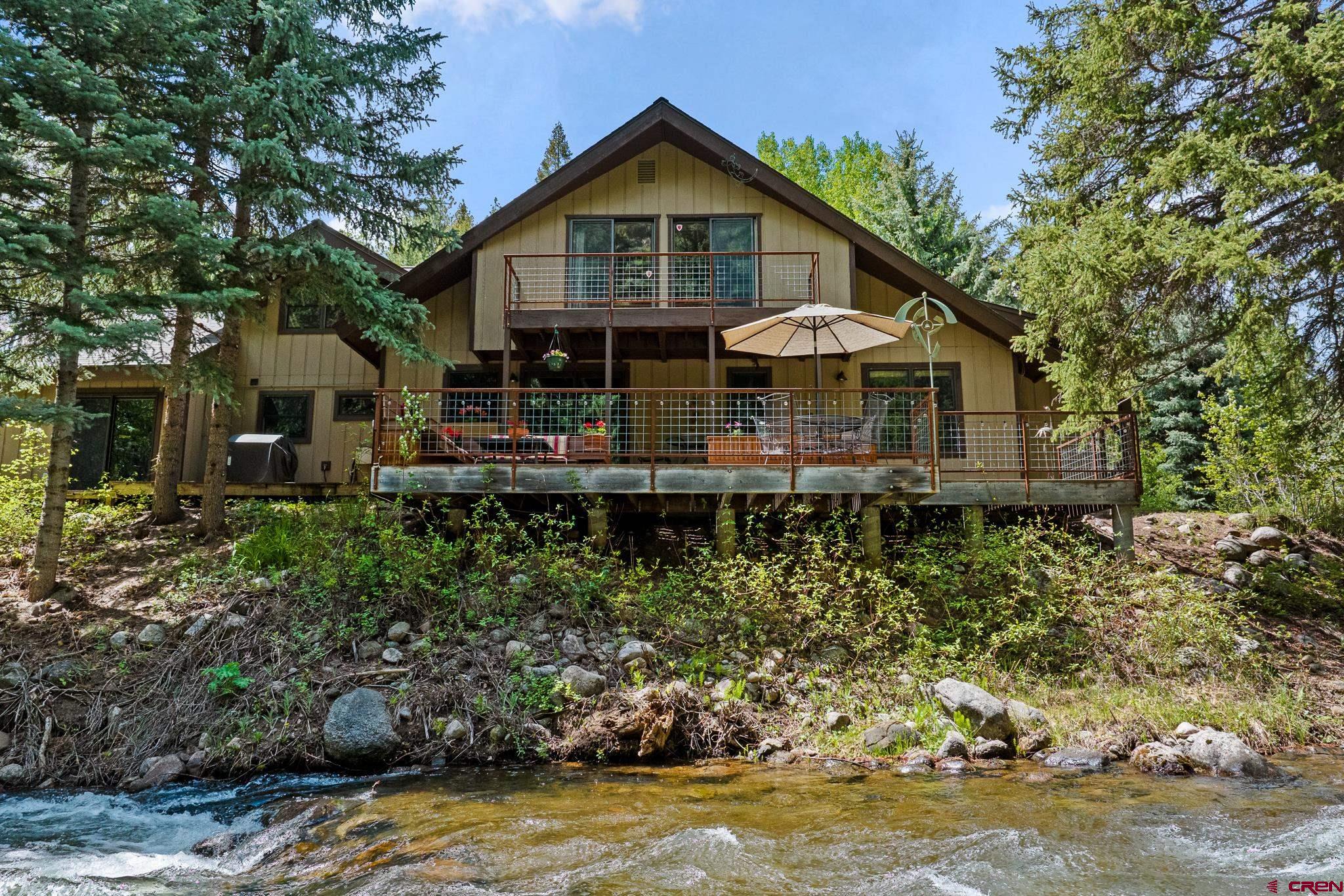 312 County Road 243 Durango, CO 81301 - Photo 2 of 33 a front view of a house with a yard and balcony