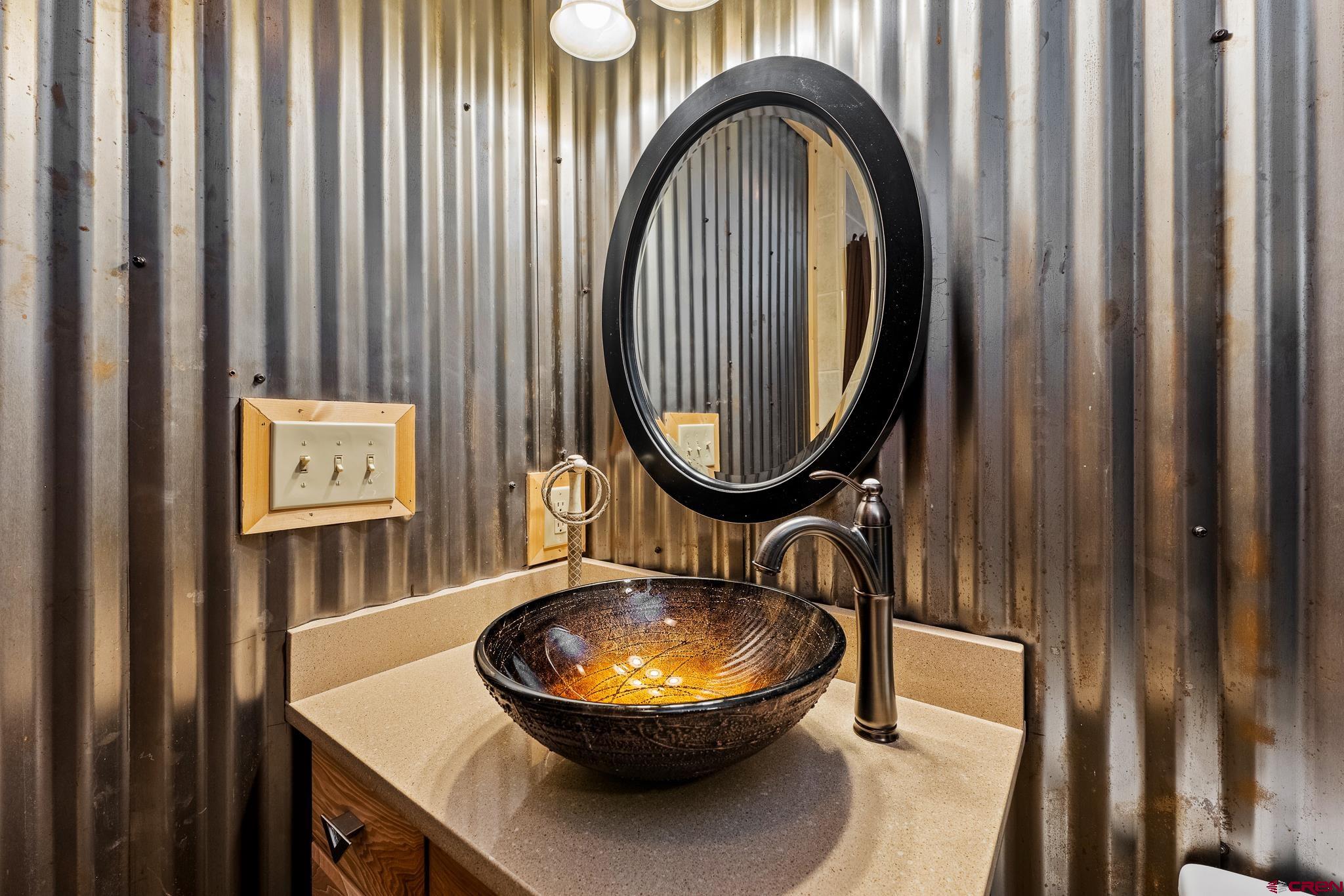 312 County Road 243 Durango, CO 81301 - Photo 29 of 33 a bathroom with a sink a mirror and a toilet