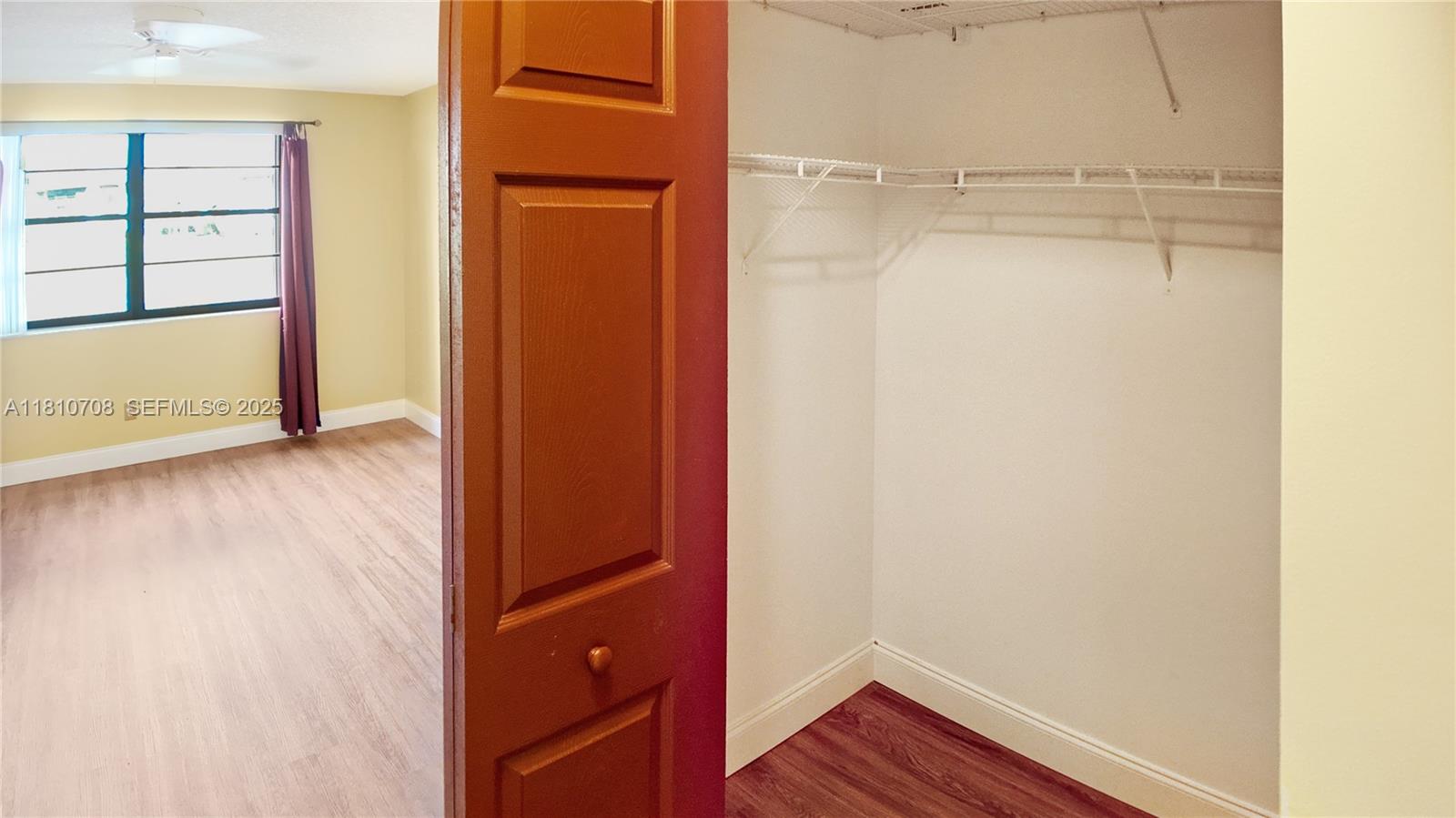 9577 West McNab Road, Unit 110 Tamarac, FL 33321 - Photo 23 of 38 a view of walk in closet with empty racks