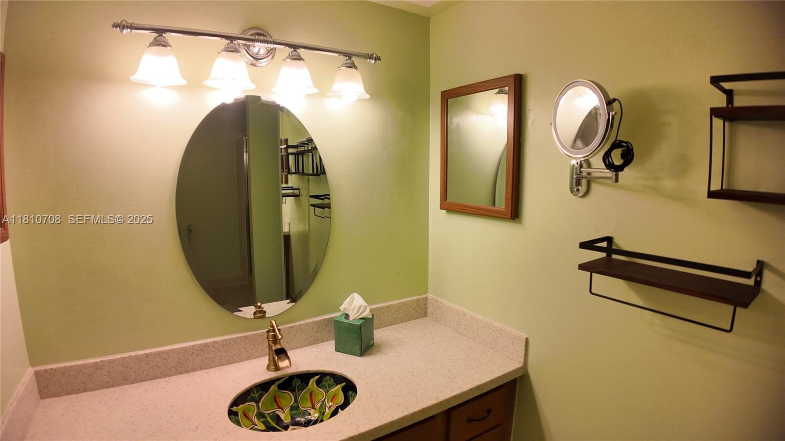 9577 West McNab Road, Unit 110 Tamarac, FL 33321 - Photo 25 of 38 a bathroom with a sink and a mirror