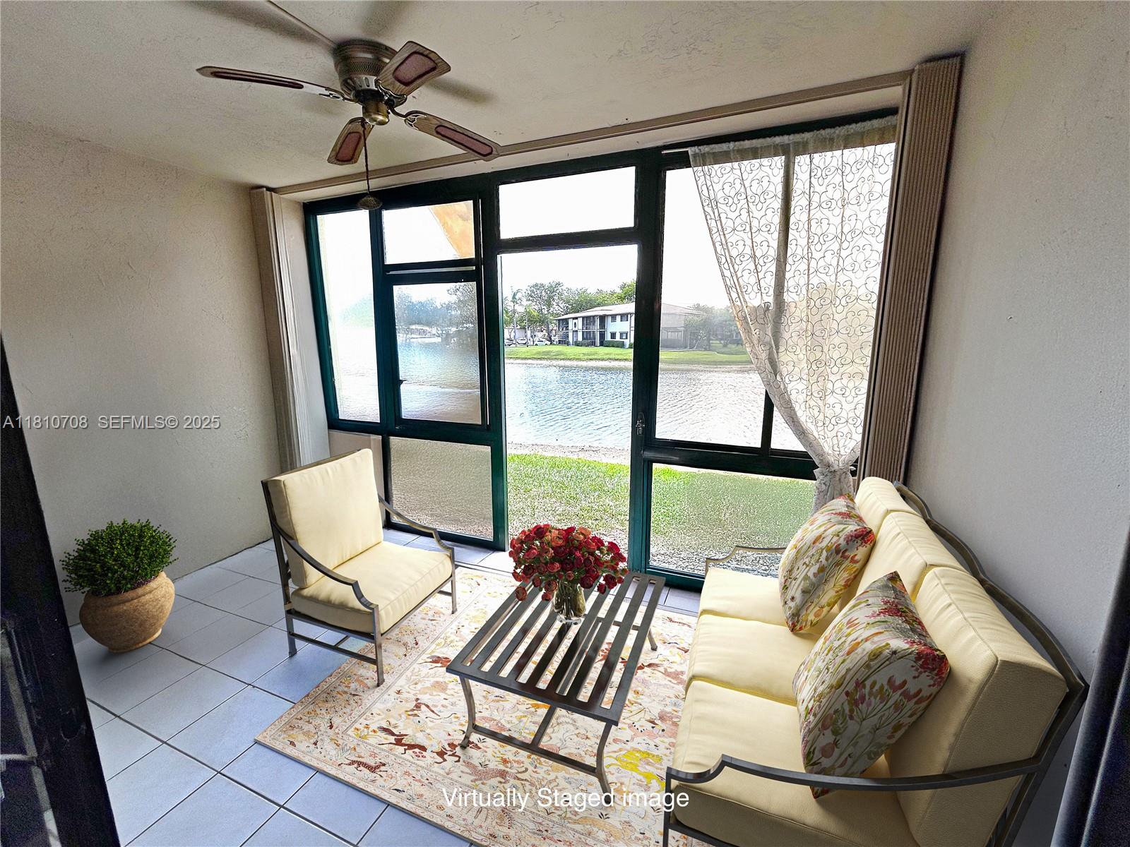 9577 West McNab Road, Unit 110 Tamarac, FL 33321 - Photo 29 of 38 a living room with furniture and a large window