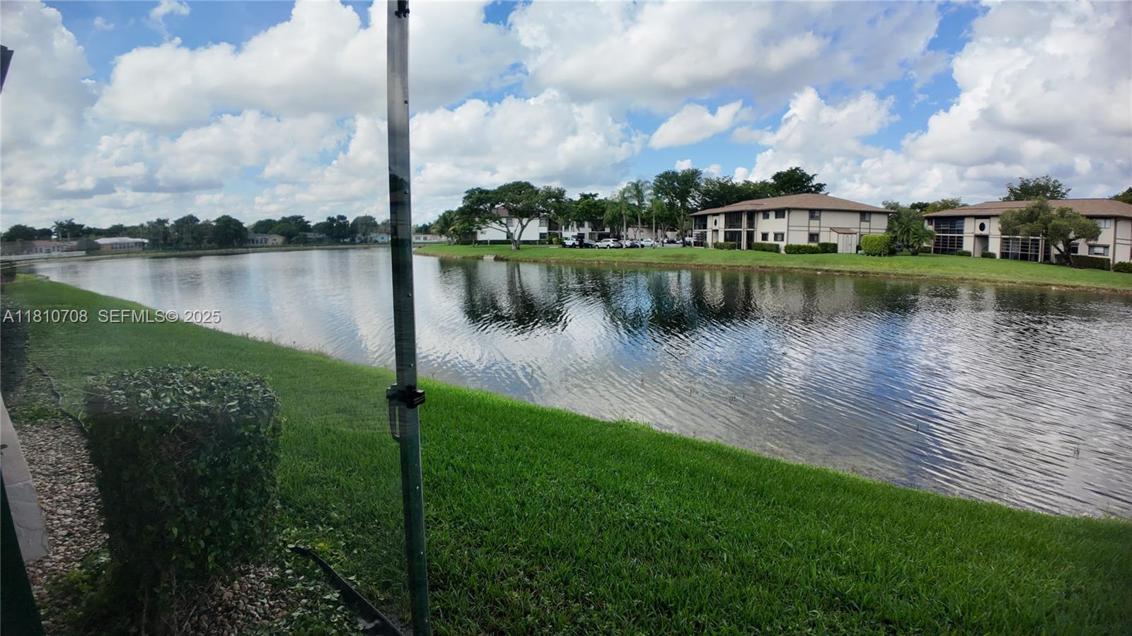 9577 West McNab Road, Unit 110 Tamarac, FL 33321 - Photo 31 of 38 a view of a lake with a city from a lake
