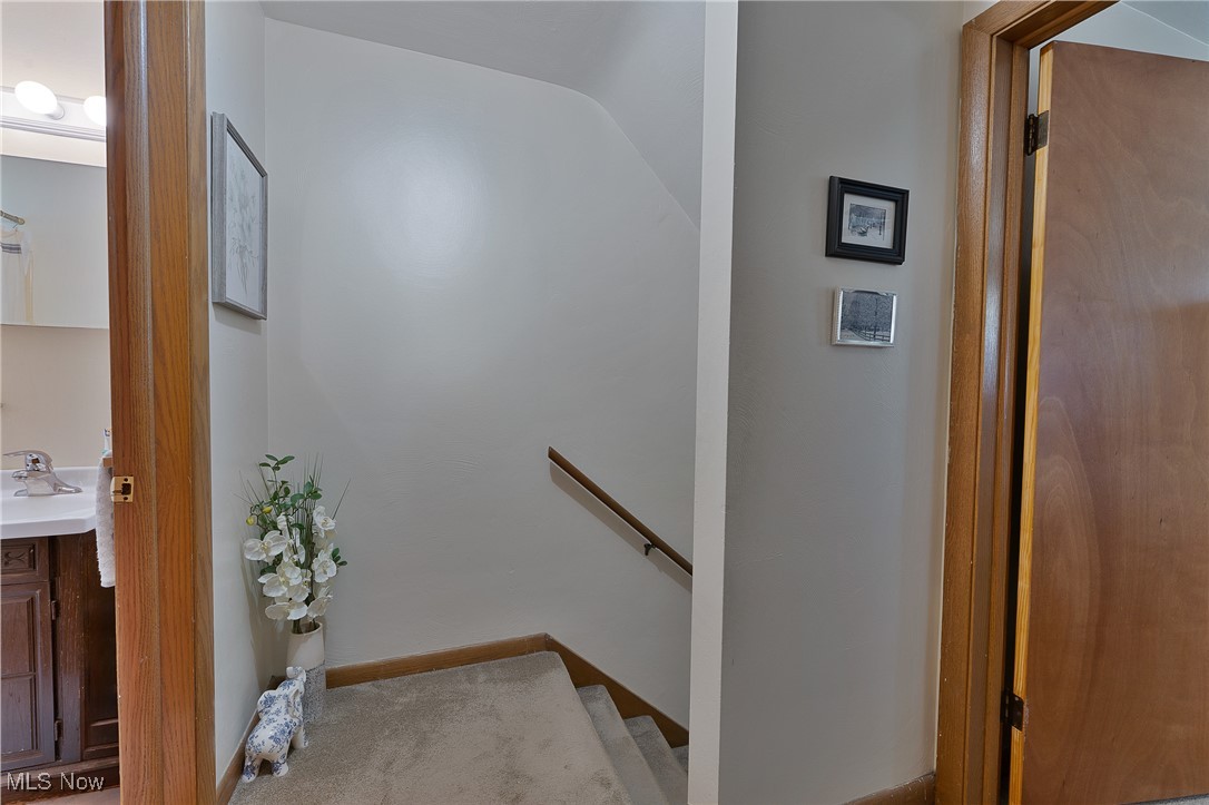 9925 Struthers Road New Middletown, OH 44442 - Photo 8 of 12 Hall featuring a sink and an upstairs landing