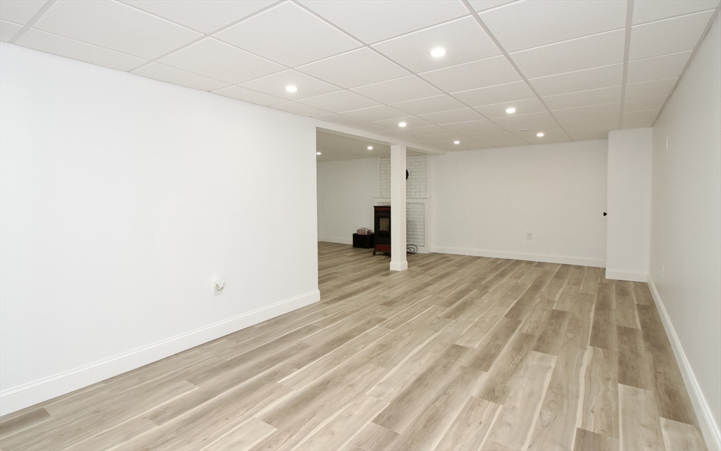 7 Barbara Road Kingston, MA 02364 - Photo 18 of 26 an empty room with wooden floor and a ceiling fan