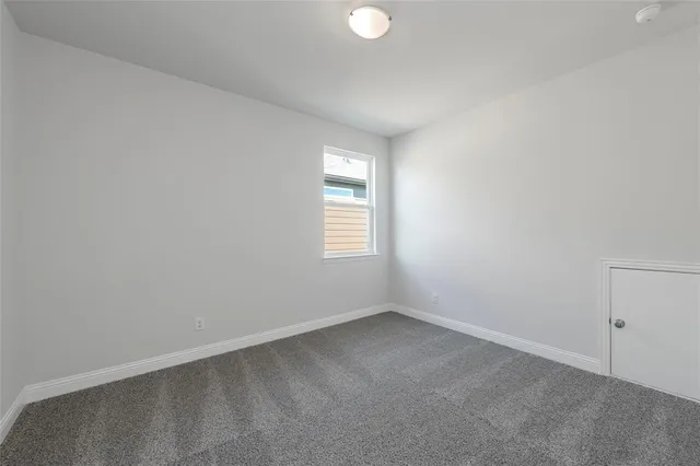 a view of a hallway with wooden floor and a living room