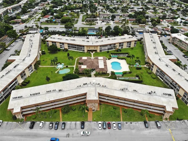 an aerial view of a building with outdoor space and street view