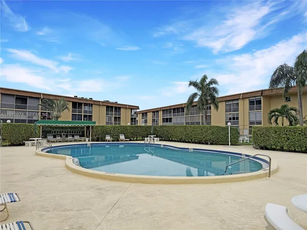 a view of a house with swimming pool and sitting area