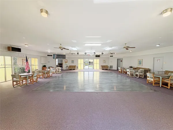 a view of a hall with dining room and wooden floor