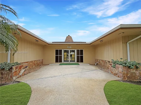 a big yard with table and chairs in patio