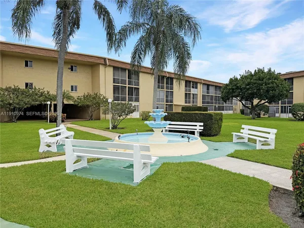 a view of a house with a yard porch and sitting area