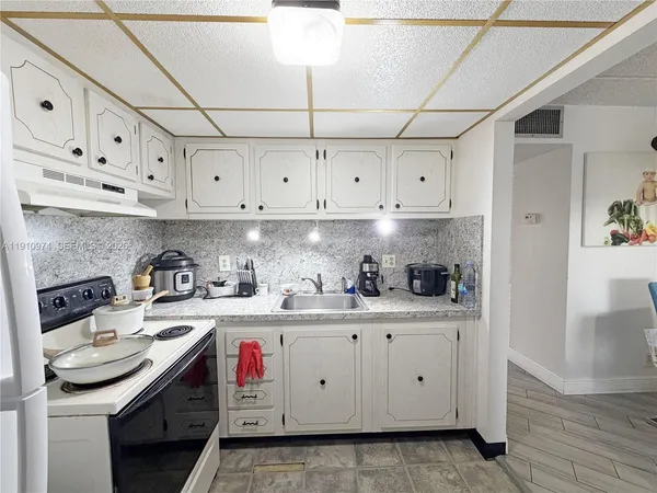 a kitchen with stainless steel appliances granite countertop a sink and cabinets
