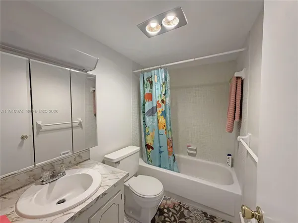 a bathroom with a sink toilet tub and shower