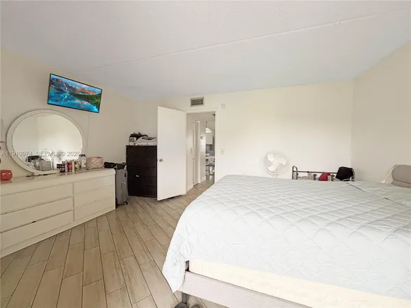 a bedroom with a bed and a dresser